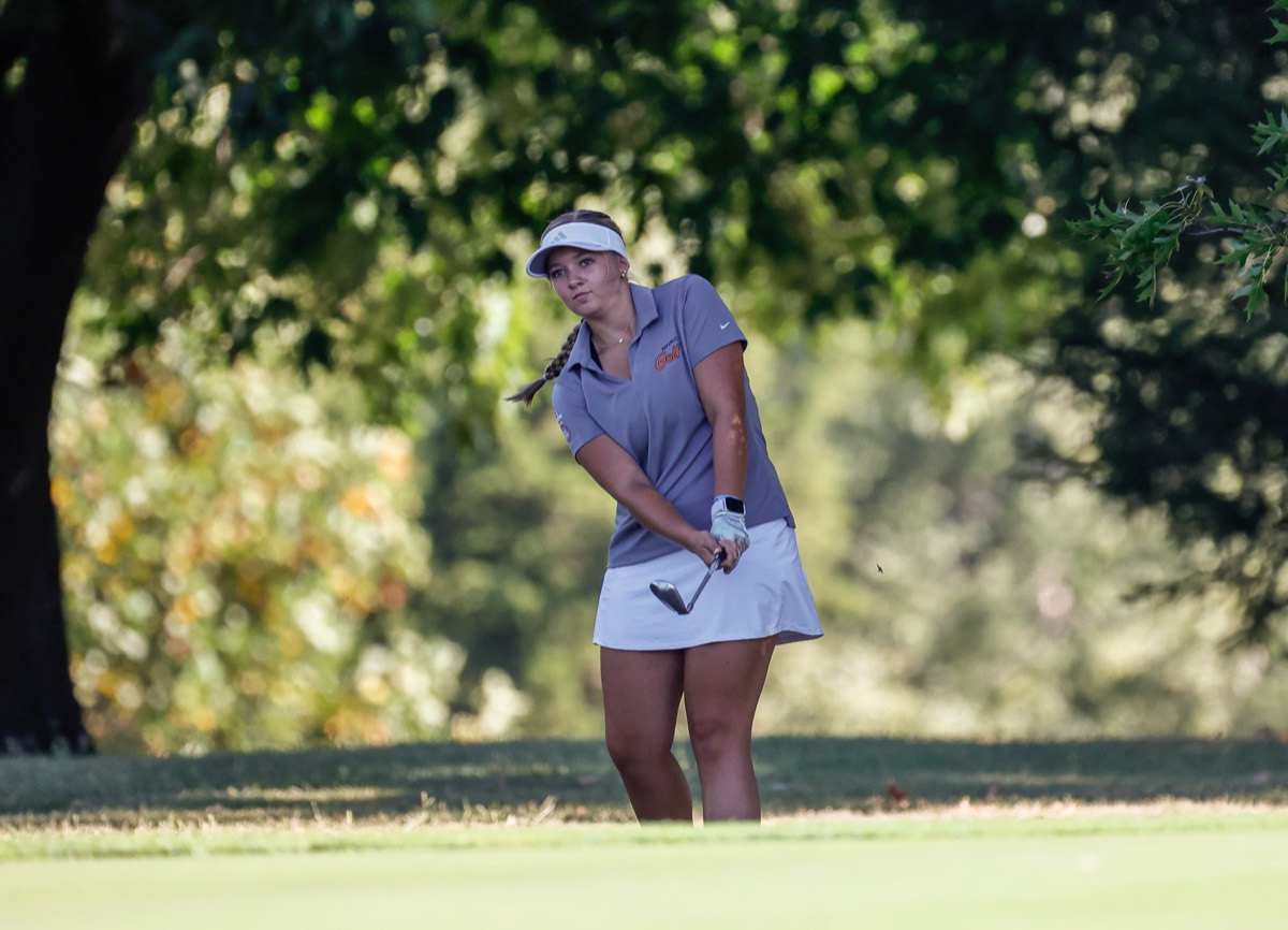 Chloe Priebe watches a chip shot after following through