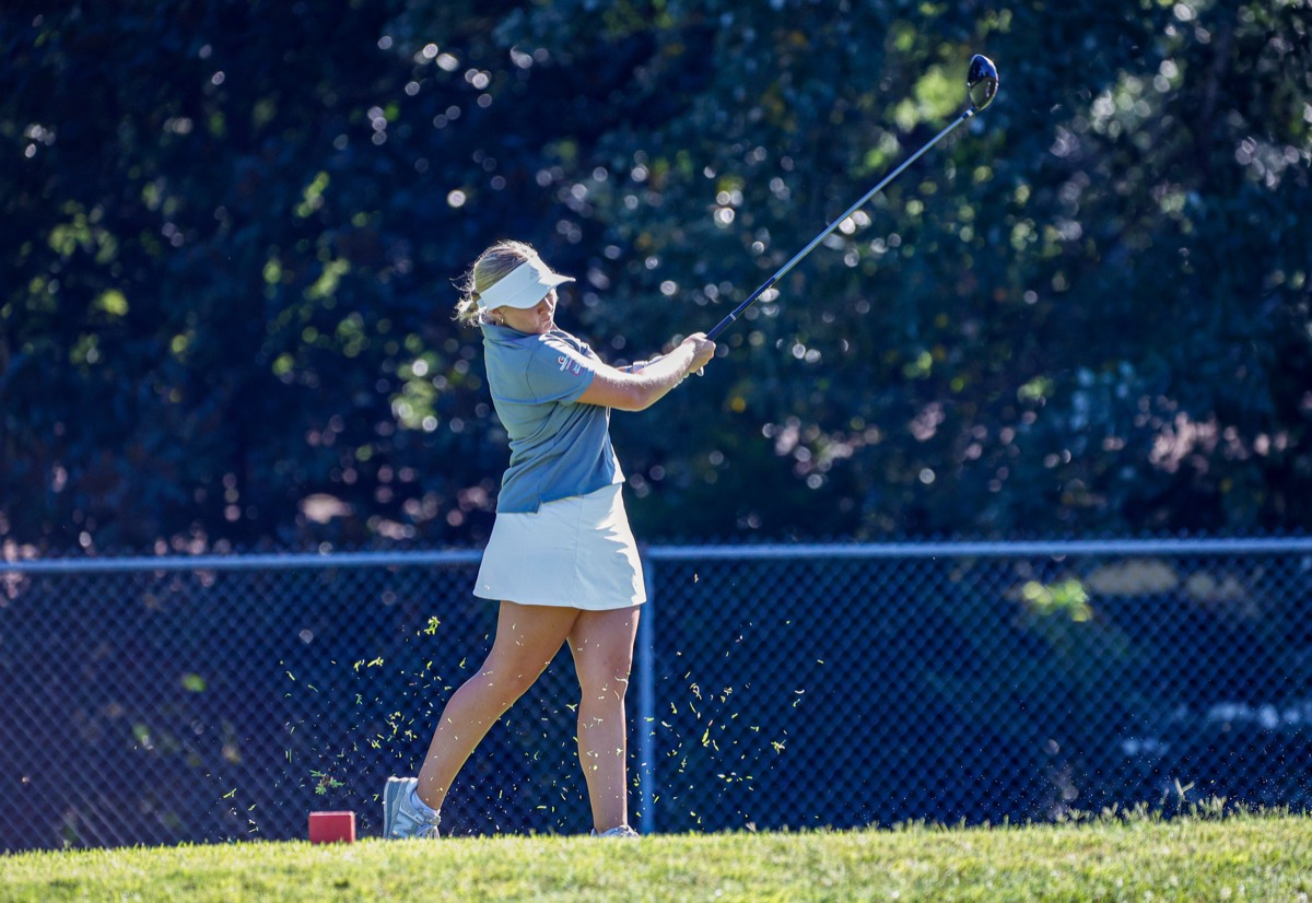 Eliza Scullawl follows through on a tee shot, driver high overhead