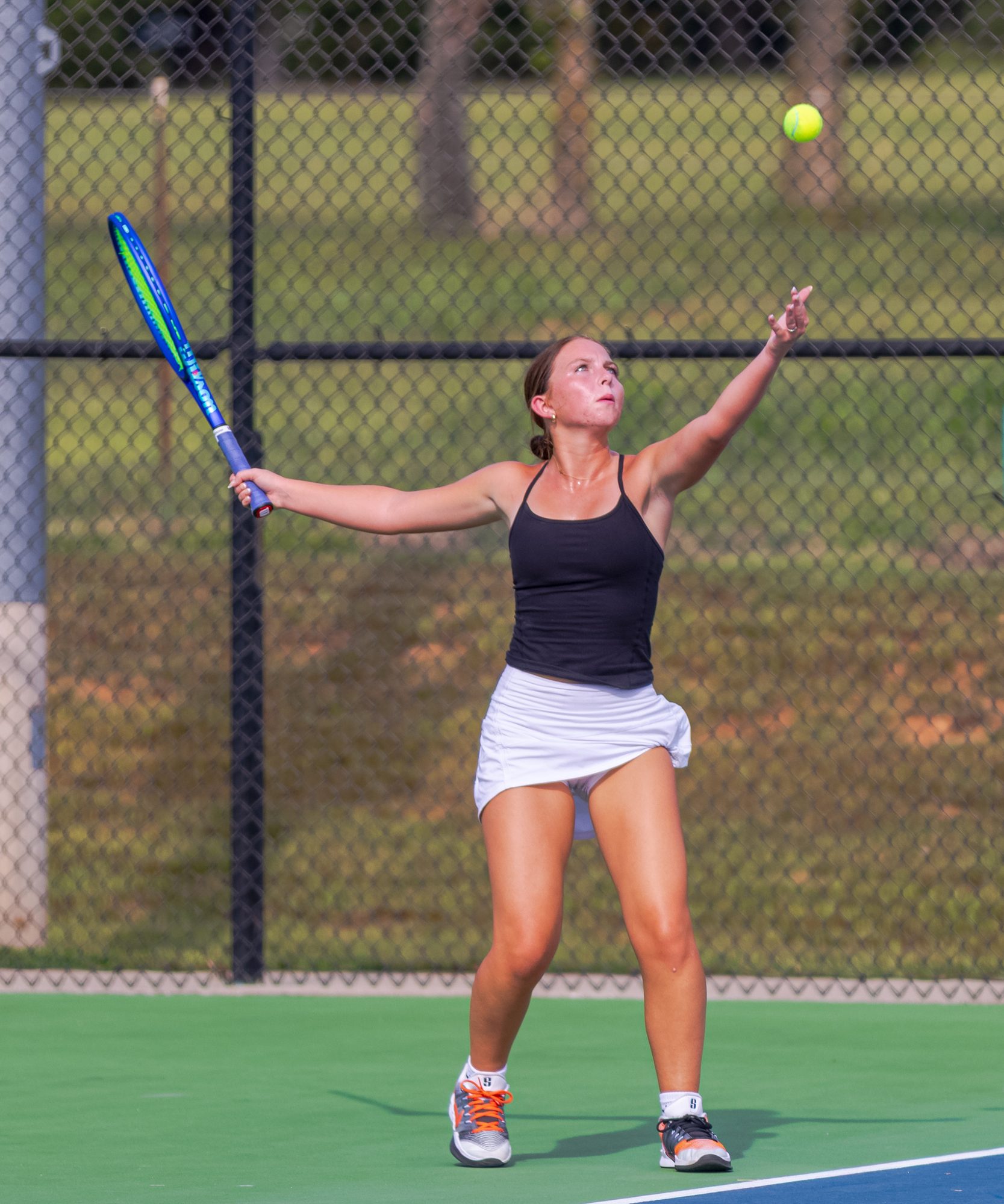 Aubree Tinsley tosses the ball to serve