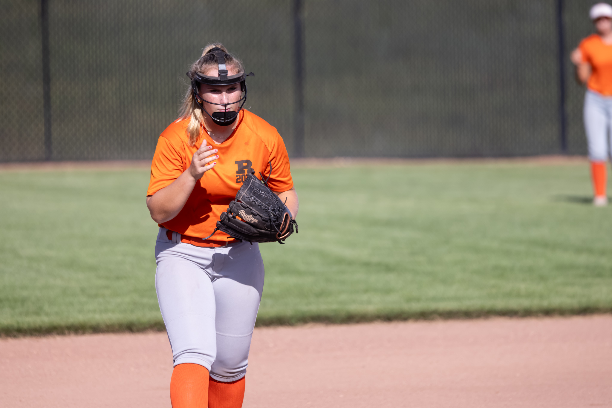 Maddie Taylor claps in the infield